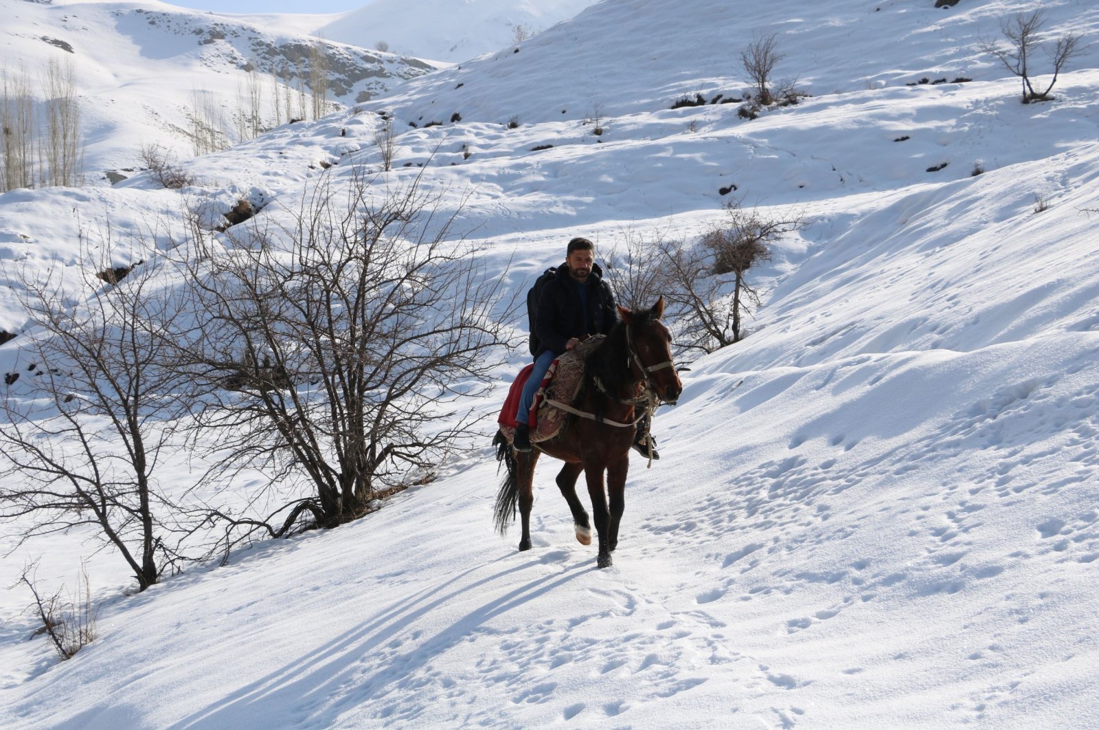 Musa Tavşan rides through a snowy field, in Hakkari, southeastern Türkiye, Dec. 28, 2022. (DHA Photo) 