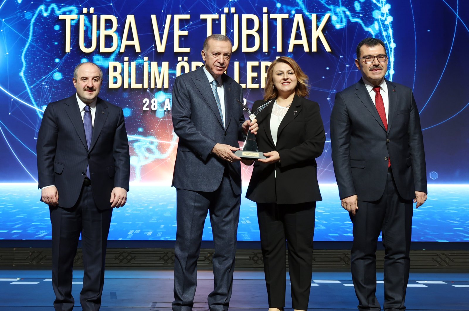 President Recep Tayyip Erdoğan hands an award to professor Özge Çevik, one of the recipients, in the capital Ankara, Türkiye, Dec. 28, 2022. (AA Photo)