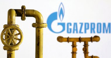 Model of natural gas pipeline and Gazprom logo are seen on this illustration taken on July 18, 2022. (Reuters Photo)
