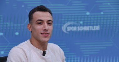 National athlete Adem Asil speaks during an interview with Anadolu Agency (AA). (AA Photo)