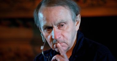 In this file photograph taken on April 20, 2022, French writer Michel Houellebecq gestures during the show &quot;Existence a Basse Altitude&quot;, a creation around a collection of his poems with music by Romain Poncet, aka Traumer, during the 46th edition of the Printemps de Bourges music festival in Bourges, central France. (AFP File Photo)