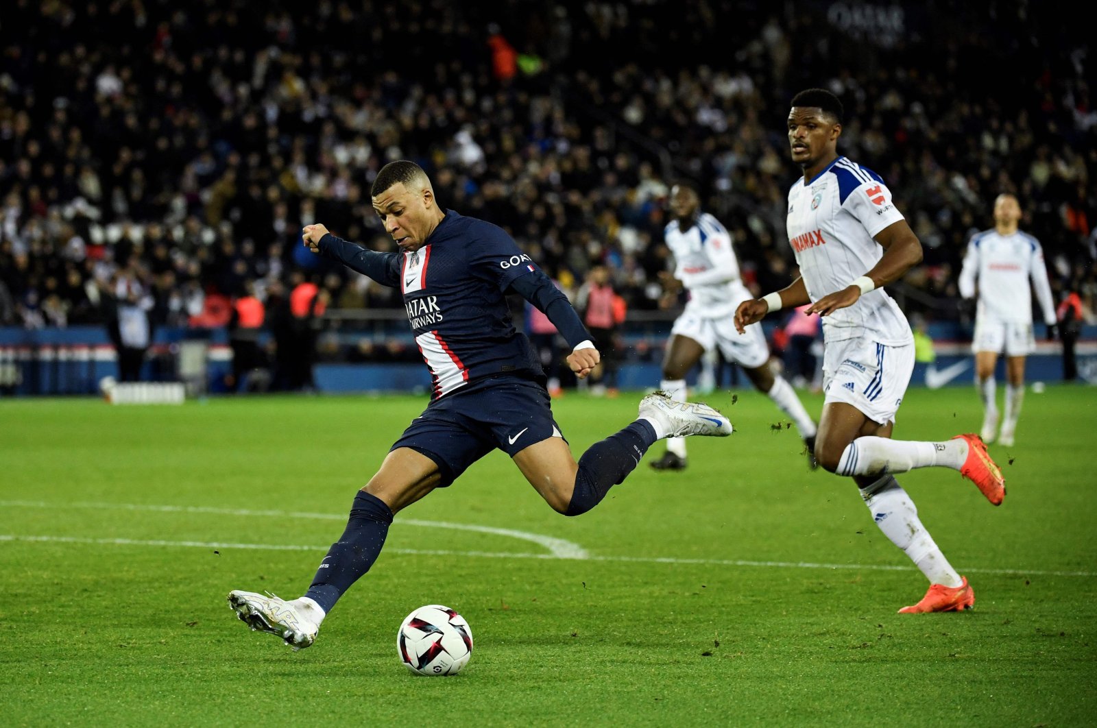 PSG&#039;s French forward Kylian Mbappe shoots the ball during the French L1 football match between Paris Saint-Germain FC and RC Strasbourg Alsace at the Parc des Princes stadium, Paris, France, Dec. 28, 2022. (AFP Photo)
