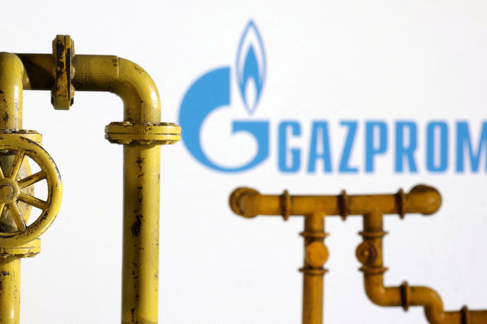 Model of natural gas pipeline and Gazprom logo are seen on this illustration taken on July 18, 2022. (Reuters Photo)