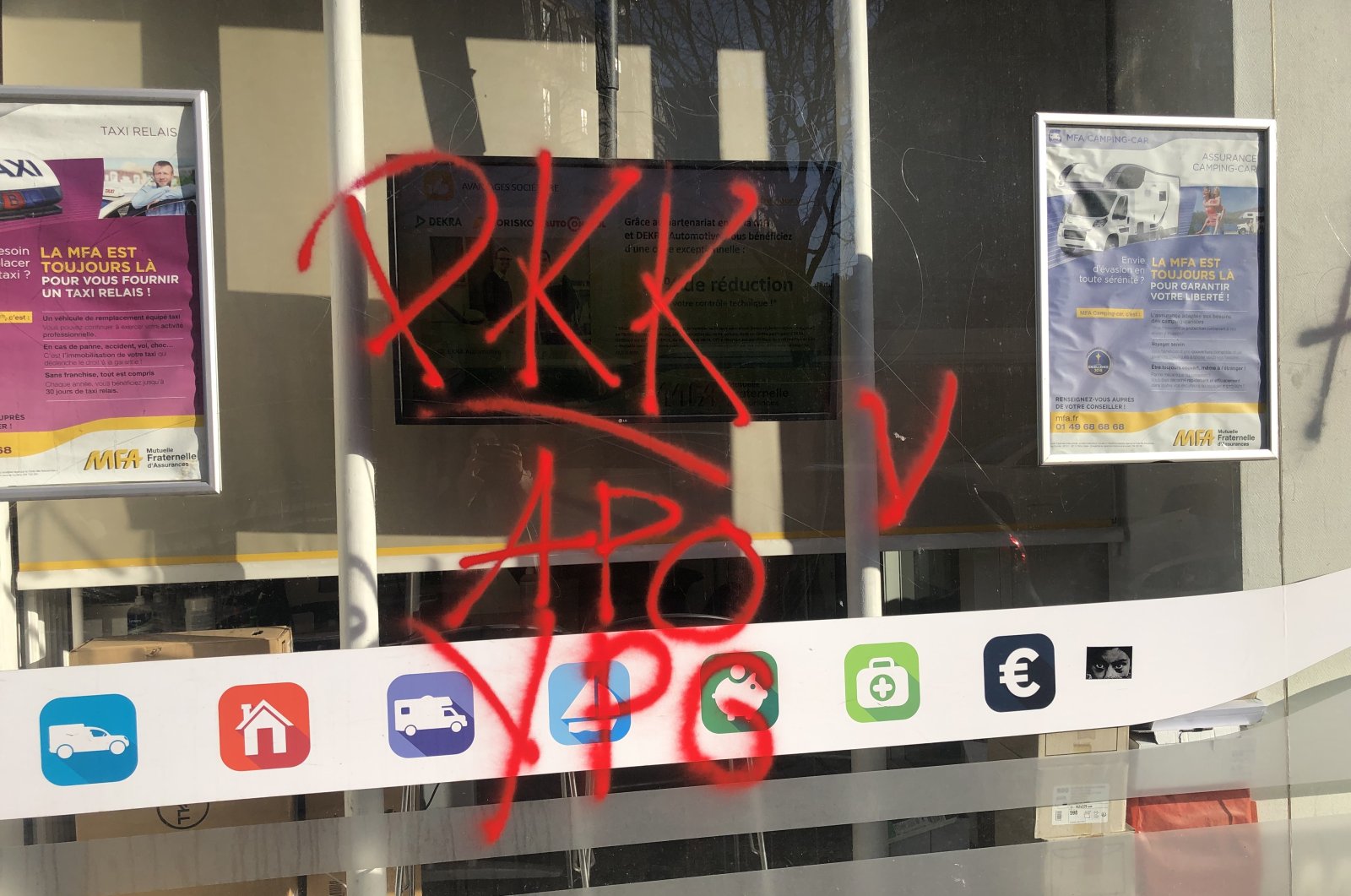 The window of a shop in Paris reads written in red spray paint the names of the terrorist organization PKK, its Syrian offshoot YPG and the nickname &quot;Apo&quot; for their jailed so-called leader Abdullah Öcalan, France, Dec. 27, 2022. (AA Photo)
