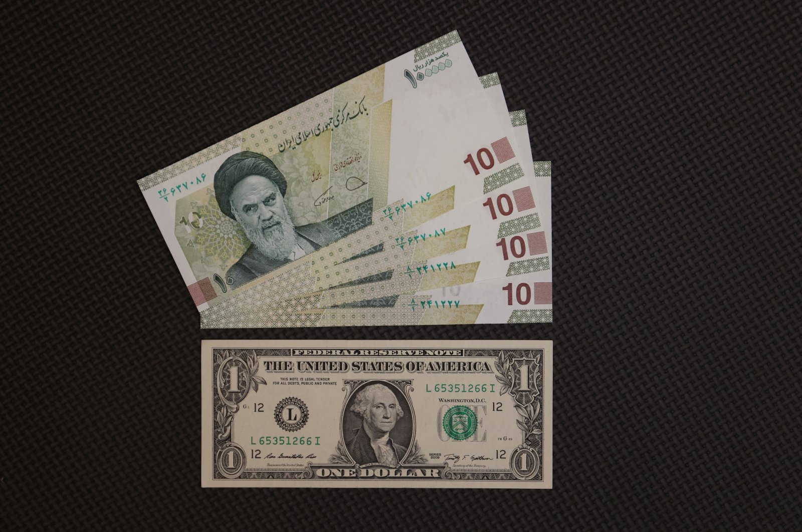 A U.S. dollar bill is seen against Iranian rial bills in an exchange shop in Tehran, Iran, Dec. 25, 2022. (Reuters Photo)