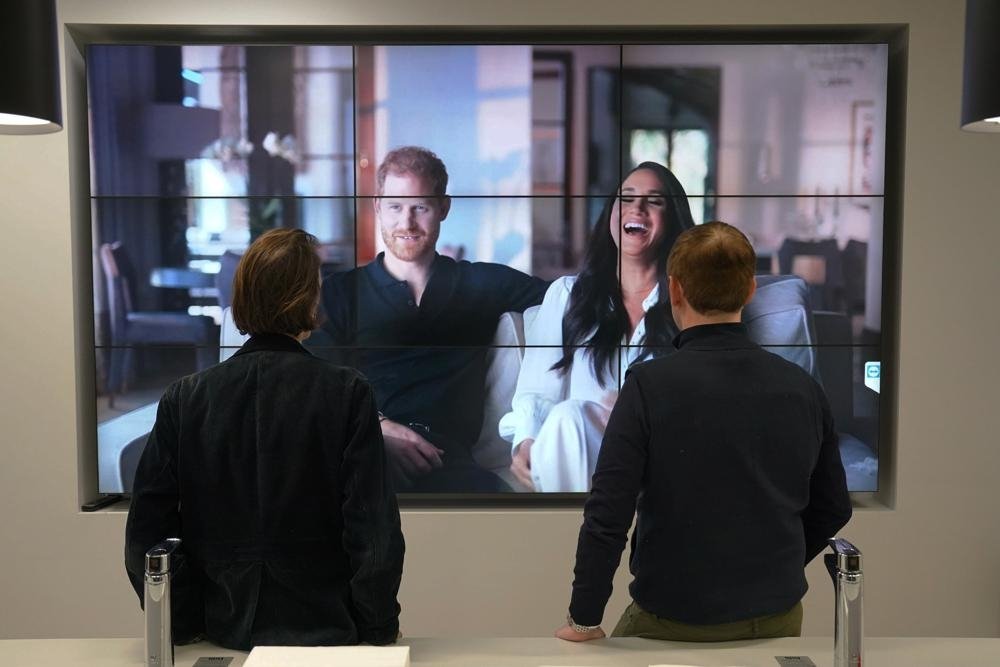 Pekerja kantoran di London menonton film dokumenter kontroversial Duke dan Duchess of Sussex yang ditayangkan di Netflix, Inggris, 8 Desember 2022. (Foto AP)