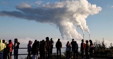 People watch smoke and steam billow from Belchatow Power Station, Europe's largest coal-fired power plant powered by lignite, in Zlobnica, Poland, Oct. 20, 2022. (Reuters Photo)
