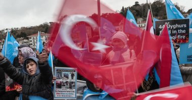 People hold posters and wave Turkish flags as they protest against China&#039;s alleged human rights violations, near the Chinese Consulate in Istanbul, Türkiye, Dec. 4, 2022. (EPA Photo)