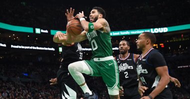 Boston Celtics forward Jayson Tatum (2L) gets fouled by LA Clippers forward Nicolas Batum (L) during the second half at TD Garden in Boston, Massachusetts, USA, Dec 29, 2022. (Reuters Photo)