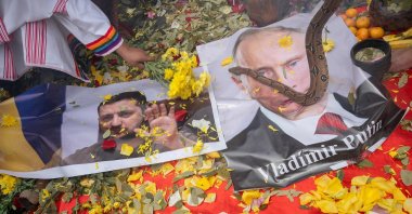 Peruvian shamans display posters of Ukrainian President Volodymyr Zelensky (L) and Russian President Vladimir Putin while executing a ritual, in Lima, Peru, Dec. 28, 2022. (AFP Photo)