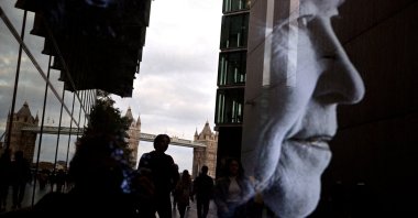 People walk as Tower Bridge is reflected in a tribute to U.K.&#039;s Queen Elizabeth II, following her death, in London, U.K., Sept. 15, 2022. (Reuters Photo)