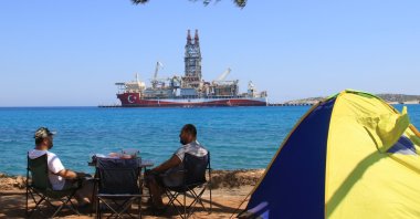 Two men camp near a port where Abdülhamid Han drillship stands docked, in Mersin, southern Türkiye, June, 20, 2022. (IHA Photo)