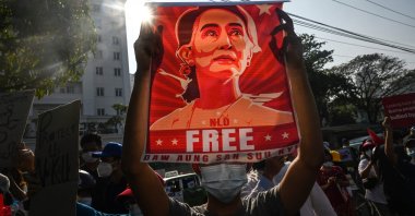 A protester holds up a poster featuring Aung San Suu Kyi during a demonstration, Yangon, Myanmar, Feb. 15, 2021. (AFP Photo)