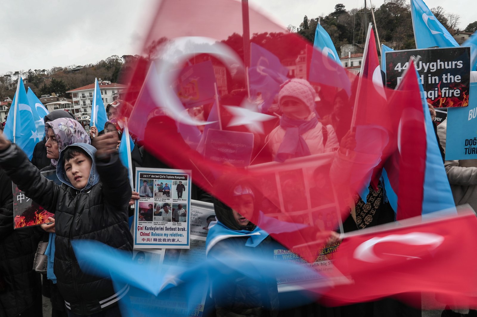 People hold posters and wave Turkish flags as they protest against China&#039;s alleged human rights violations, near the Chinese Consulate in Istanbul, Türkiye, Dec. 4, 2022. (EPA Photo)