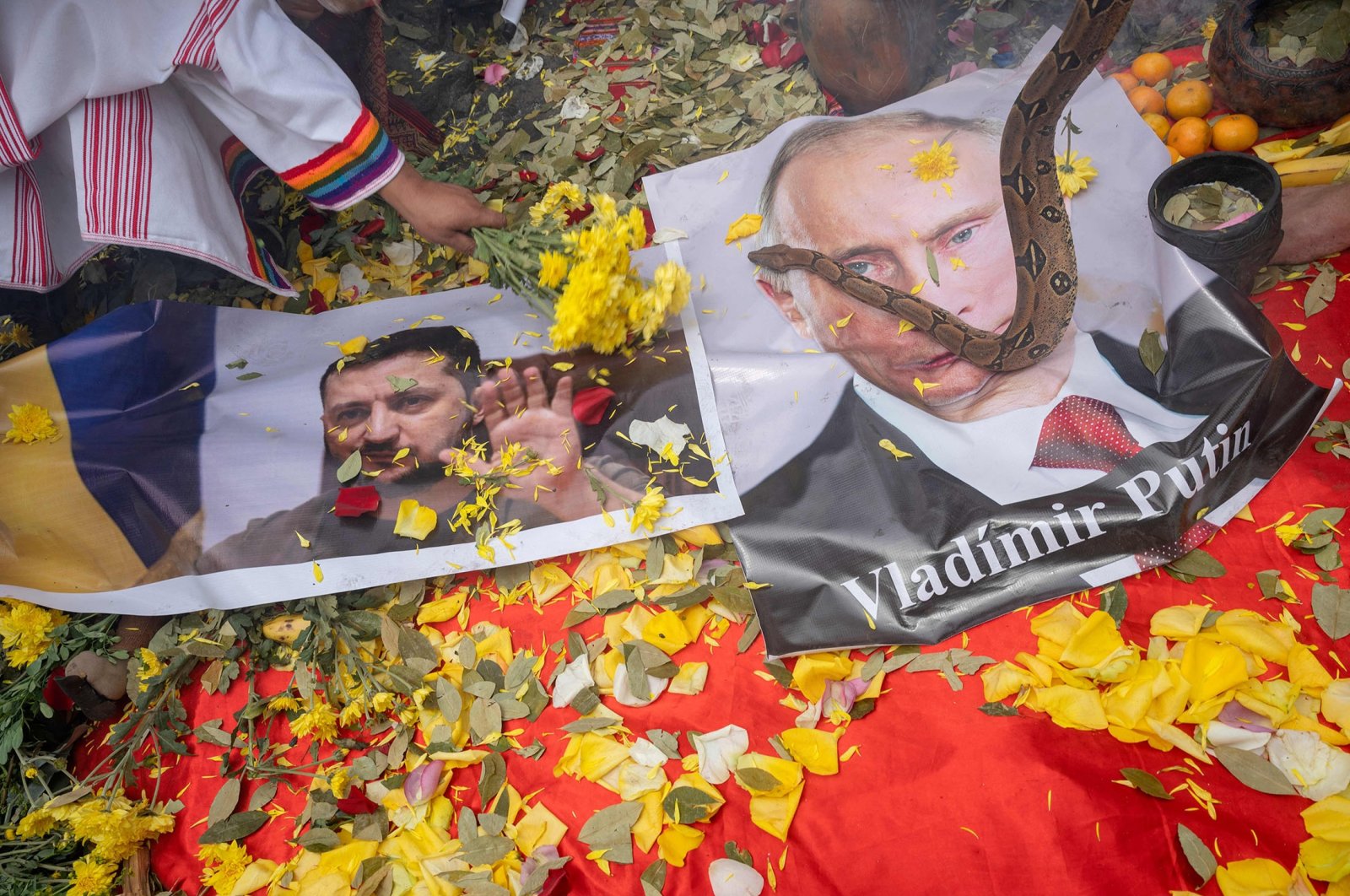 Peruvian shamans display posters of Ukrainian President Volodymyr Zelensky (L) and Russian President Vladimir Putin while executing a ritual, in Lima, Peru, Dec. 28, 2022. (AFP Photo)
