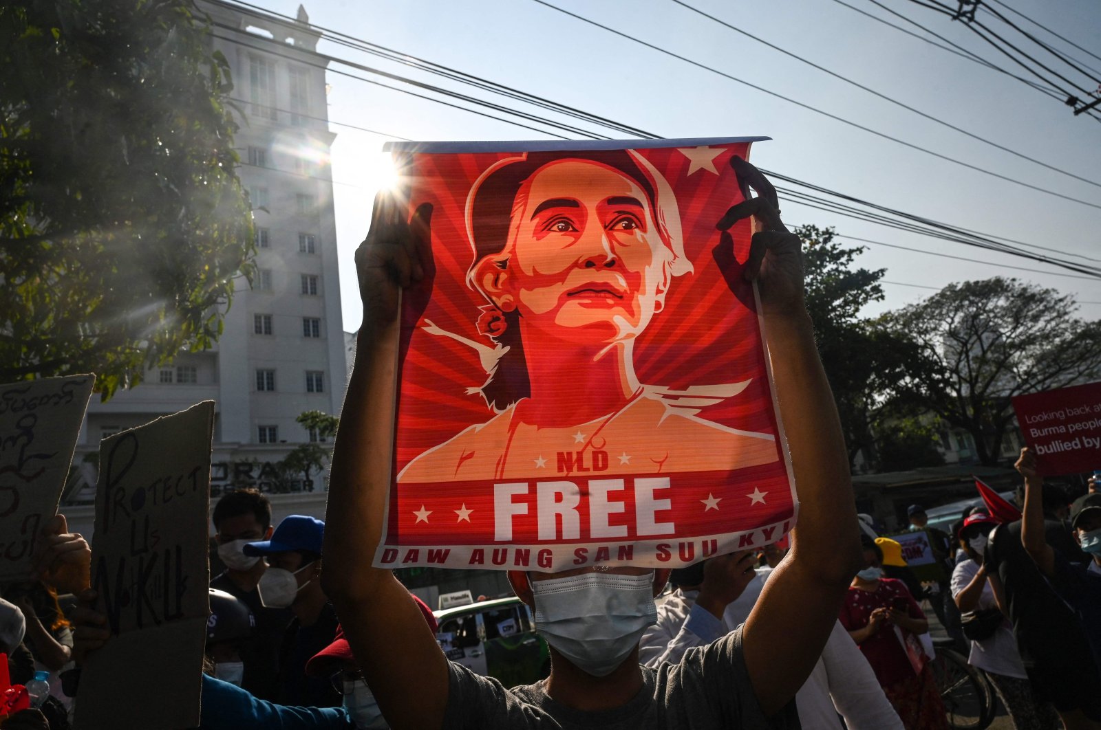A protester holds up a poster featuring Aung San Suu Kyi during a demonstration, Yangon, Myanmar, Feb. 15, 2021. (AFP Photo)