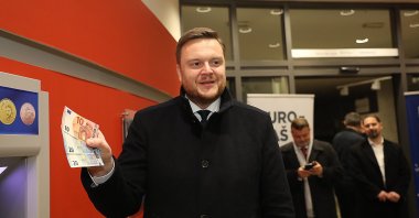 Croatian Finance Minister Marko Primorac withdraws euro banknotes at an ATM in Zagreb, Croatia, Jan. 1, 2023. (EPA Photo)