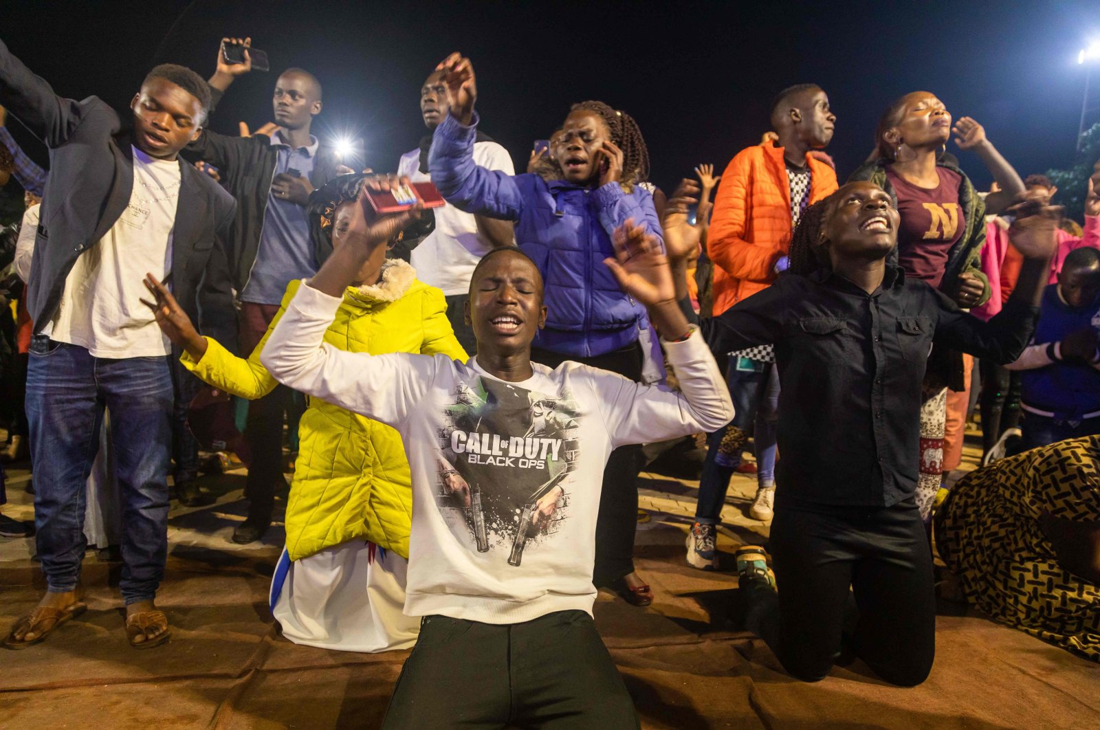 People celebrate after the countdown to the new year at Miracle Center Cathedral in Kampala, Uganda, Jan. 1, 2023. (AFP Photo)