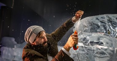 An artist works on the sphinx figure displayed in the ice museum, Erzurum, Türkiye, Dec. 28, 2022. (AA Photo)