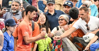 Serbia&#039;s Novak Djokovic signs autographs for fans after losing his first round doubles match with partner Vasek Pospisil of Canada during the 2023 Adelaide International Tennis Tournament at the Memorial Drive Tennis Centre, Adelaide, Australia, Jan. 2 2023. (EPA Photo)