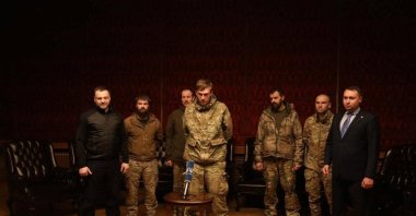 High-ranking members of Ukraine's Azov Battalion, Denys Prokopenko, Sviatoslav Palamar and Denys Shleha, stand next to Ukraine's intelligence chief Kyrylo Budanov as they speak to Ukrainian President Volodymyr Zelenskyy via video link after the prisoner swap, Ukraine, Sept. 22, 2022. (Reuters Photo)