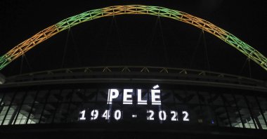 Wembley Stadium's arch is lit up in the colors of Brazil after it was announced that the former Brazilian footballer Pele had died, in London, Thursday, Dec. 29, 2022. (AP Photo)