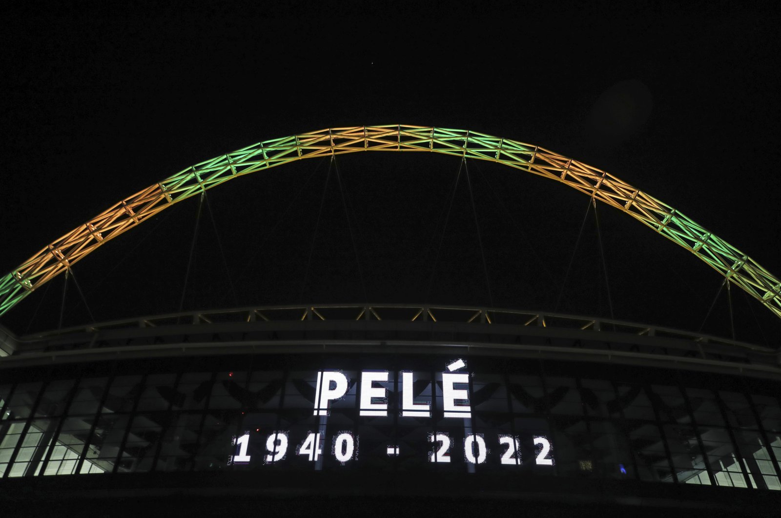 Wembley Stadium&#039;s arch is lit up in the colors of Brazil after it was announced that the former Brazilian footballer Pele had died, in London, Thursday, Dec. 29, 2022. (AP Photo)