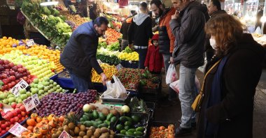 Customers buy vegetables and fruit at a public market in the historical district of Ulus in Ankara, Türkiye, Dec. 30, 2022. (AFP Photo)