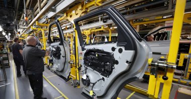 Staff members assemble door panels on the production line at Jaguar Land Rover's Halewood factory in Liverpool, Britain, Dec. 6, 2022. (Reuters Photo)