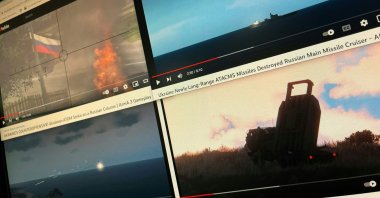 A computer screen shows four YouTube windows displaying combat clips from Arma 3's war-themed video games, Washington, U.S., Dec. 28, 2022. (AFP Photo)