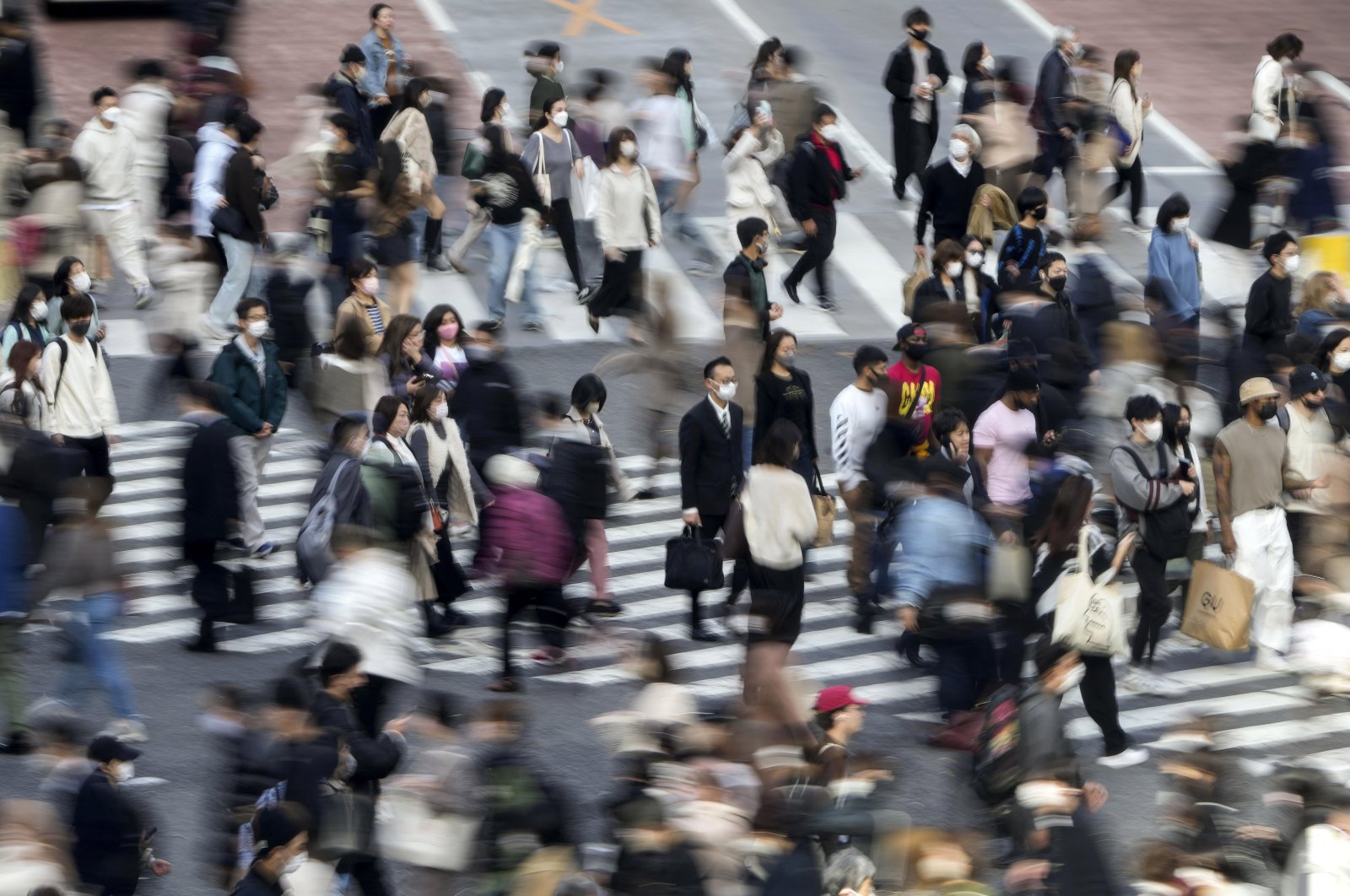 Pedestrians cross a street in the Shibuya district of Tokyo, Japan, Nov. 24, 2022. (EPA Photo)