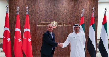 Foreign Minister Mevlüt Çavuşoğlu (L) shakes hands with UAE Foreign Minister Sheikh Mohammed bin Abdulrahman Al Thani at a meeting, in Dubai, UAE, Dec. 17, 2021. (AA Photo)