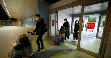 Chinese travelers leave Rome Fiumicino International Airport after being tested for the coronavirus, near Rome, Italy, Dec. 29, 2022. (AFP Photo)