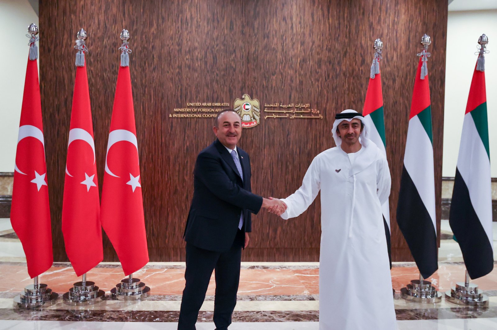 Foreign Minister Mevlüt Çavuşoğlu (L) shakes hands with UAE Foreign Minister Sheikh Mohammed bin Abdulrahman Al Thani at a meeting, in Dubai, UAE, Dec. 17, 2021. (AA Photo)