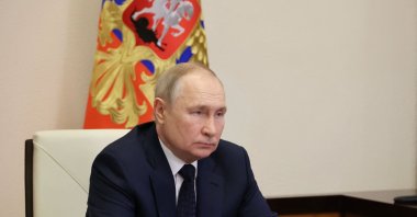 Russian President Vladimir Putin listens to the report of Russian Defence Minister Sergei Shoigu and Commander of the Admiral Gorshkov frigate Igor Krokhmal before a ceremony to launch the Admiral Gorshkov frigate to the combat mission, via a video conference in Moscow, Russia, on Jan. 4, 2023. (Photo by Mikhail Klimentyev / Sputnik / AFP)