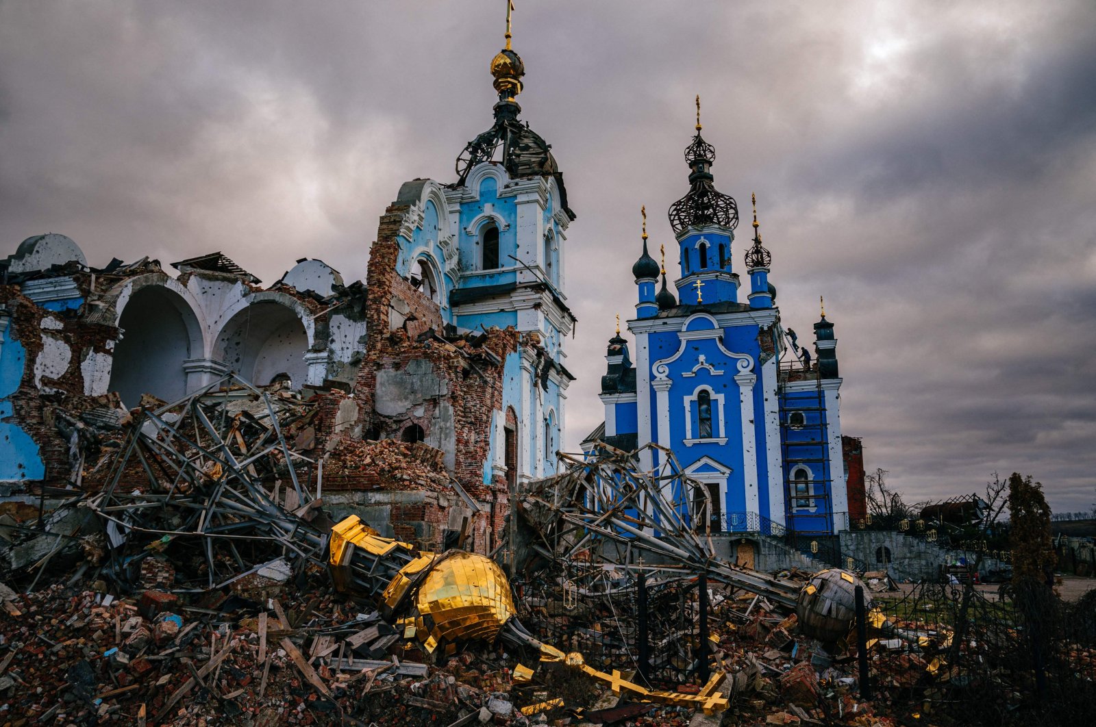 Construction workers climb onto the roof of a destroyed church in the village of Bohorodychne, Donetsk region, Ukraine, Jan. 4, 2023. (AFP Photo)
