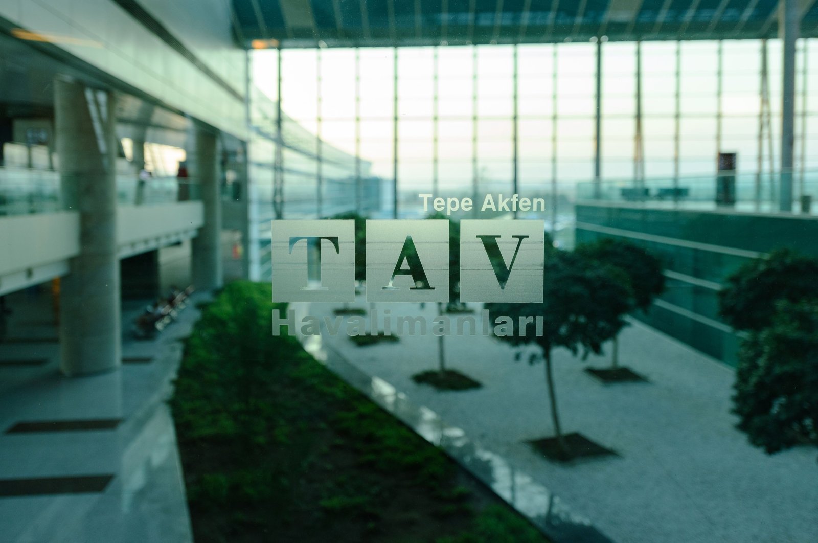 The TAV Airports Holding logo is printed on glass at the Esenboğa International Airport, Ankara, Türkiye, Aug. 19, 2017. (Shutterstock Photo)