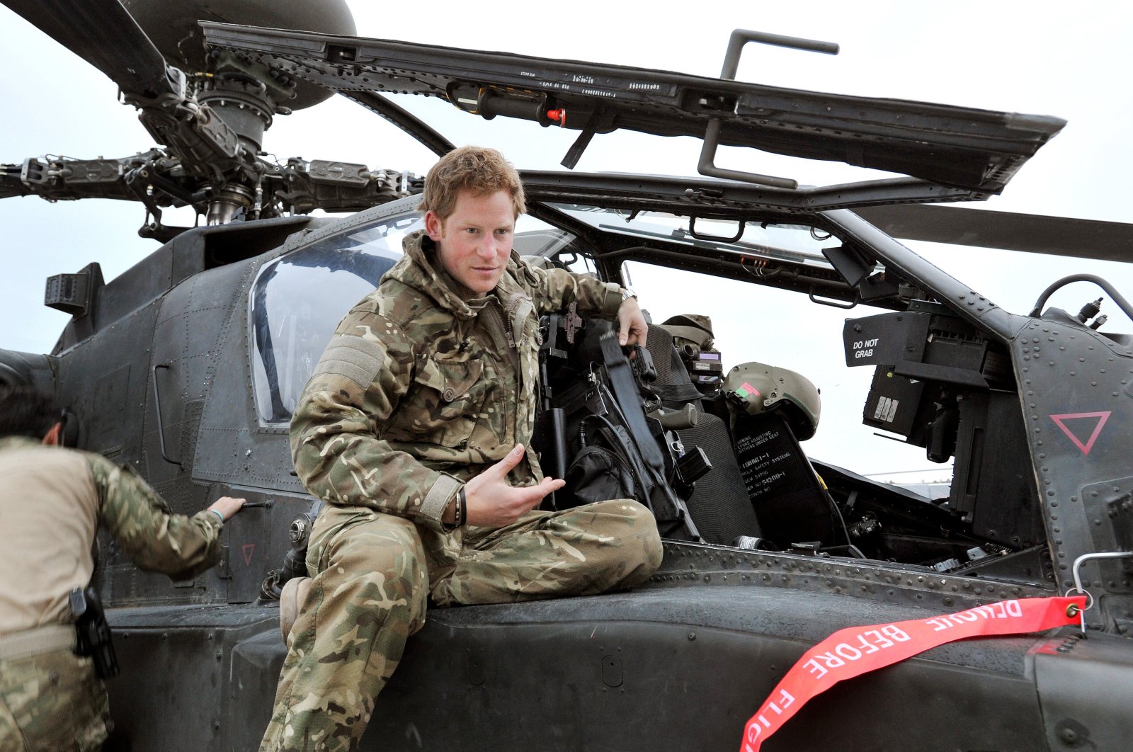 In this file photo dated Dec. 12, 2012, made public on Jan. 21, 2013, Britain&#039;s Prince Harry talks to a TV crew after an early morning pre-flight checks on the flight-line, from Camp Bastion, southern Afghanistan. (AP Photo)