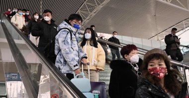 Passengers arrive at a train station, Bengbu, China, Jan. 5, 2023. (AFP Photo)