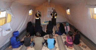 Civil defense members talk to Syrians during a cholera awareness campaign, at a camp in Idlib, Syria, Sept. 24, 2022. (Reuters Photo) 