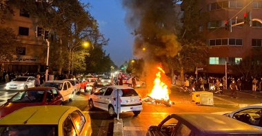 A police motorcycle burns during a protest over the death of Mahsa Amini, in Tehran, Iran, Sept. 19, 2022. (Reuters Photo)