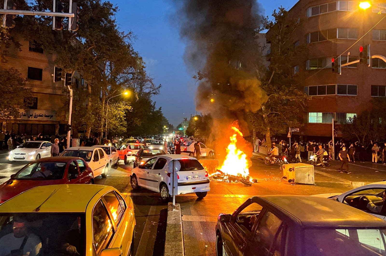A police motorcycle burns during a protest over the death of Mahsa Amini, in Tehran, Iran, Sept. 19, 2022. (Reuters Photo)
