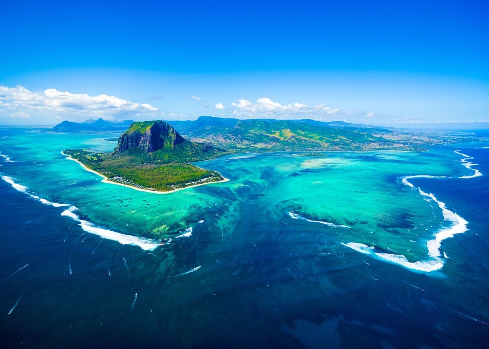 Aerial view of Mauritius island panorama and famous Le Morne Brabant mountain, beautiful blue lagoon and underwater waterfall. (Shutterstock Photo)