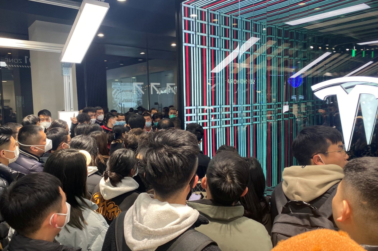 People protest at a Tesla showroom in Chengdu, Sichuan, China, in this picture released Jan. 6, 2023, and obtained by Reuters from social media. (Reuters Photo)