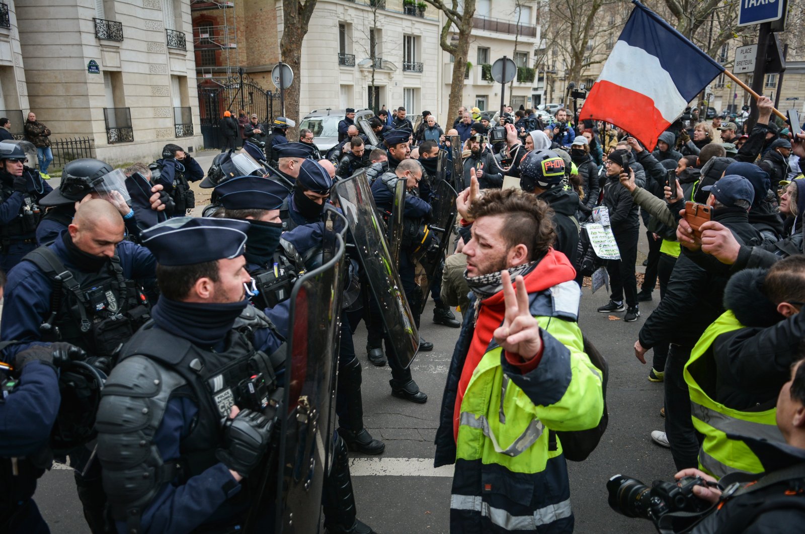 Protestesters in yellow high-visibility vests confront police in central Paris, France, Jan. 7, 2022. (AA Photo)