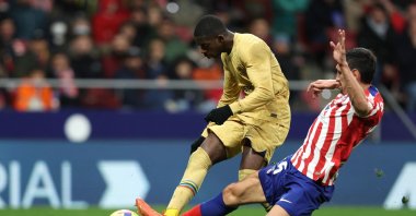 Atletico Madrid's Montenegrin defender Stefan Savic (R) tackles Barcelona's French forward Ousmane Dembele during the Spanish League football match between Club Atletico de Madrid and FC Barcelona at the Wanda Metropolitano stadium, Madrid, Spain, Jan.8, 2023. (AFP Photo)
