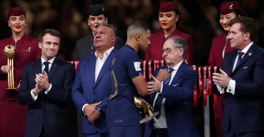 French Football Federation President Noel Le Graet congratulates Kylian Mbappe during the awards ceremony after the FIFA World Cup Qatar 2022 final match between Argentina and France at Lusail Stadium, Lusail City, Qatar, Dec. 18, 2022. (Getty Images Photo)