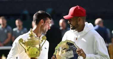 Serbia's Novak Djokovic poses with the trophy after winning the Wimbledon men's singles final alongside runner up Australia's Nick Kyrgios, London, U.K., July 2022. (Reuters Photo)