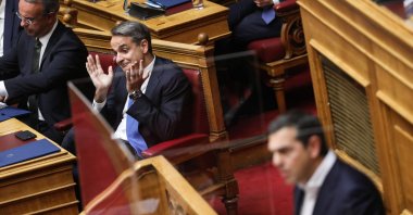Greek Prime Minister Kyriakos Mitsotakis (2-L) reacts as he listens to the speech of Alexis Tsipras (R), leader of the main opposition party Syriza, during a parliamentary debate prior to a vote on the 2023 state budget, Athens, Greece, Dec. 17, 2022. (EPA Photo)