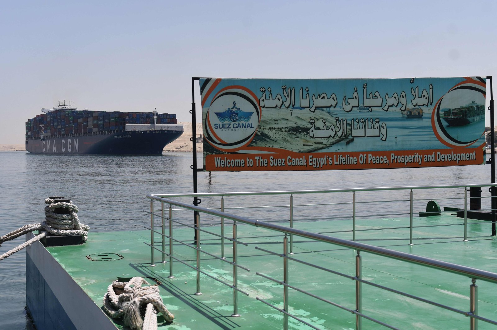 A welcoming sign is placed on the shore of the Suez Canal in the northeastern Egyptian city of Ismailia, Egypt, May 27, 2021. (AFP Photo)